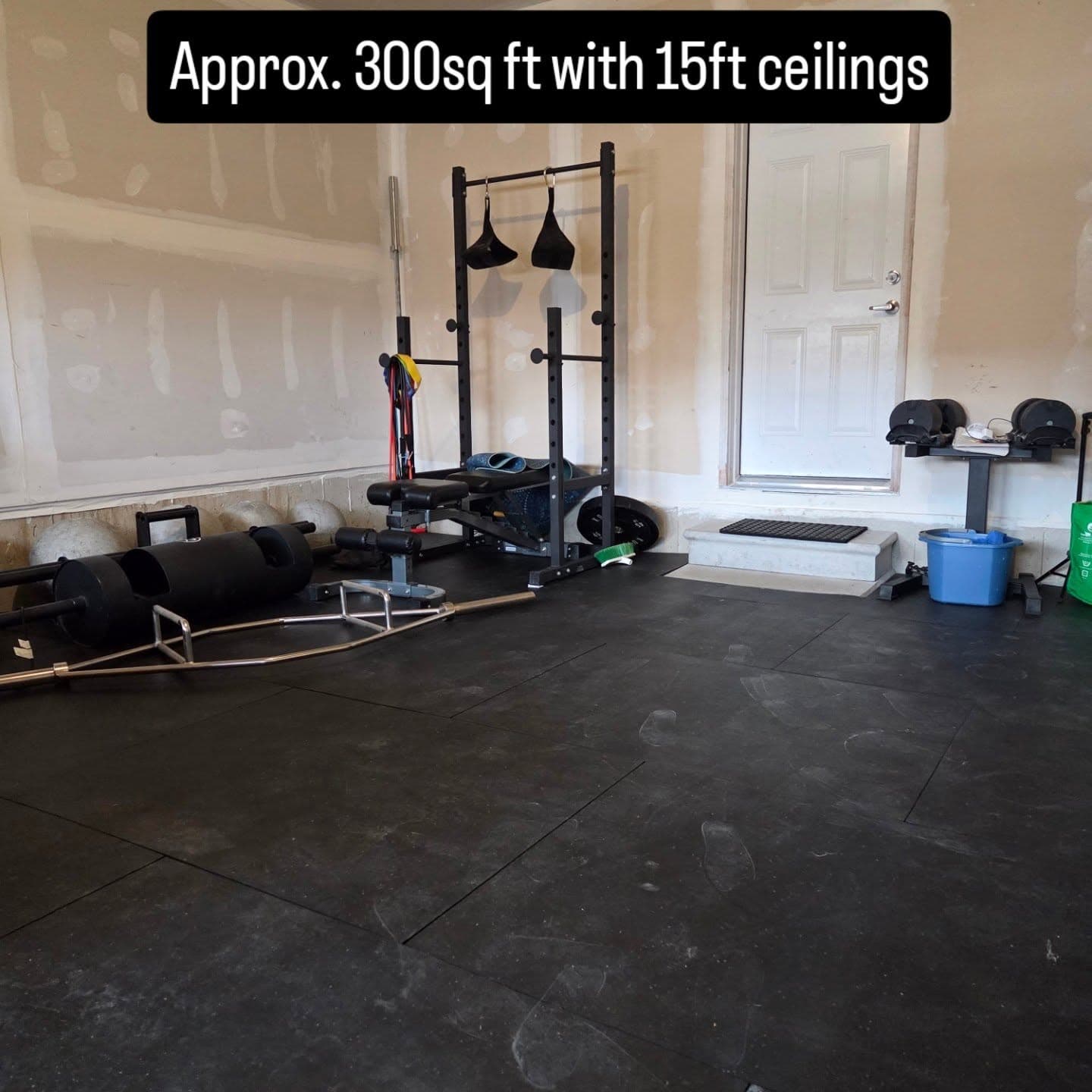 Trap bar, bench, and plate loaded equipment inside SWALLFitness